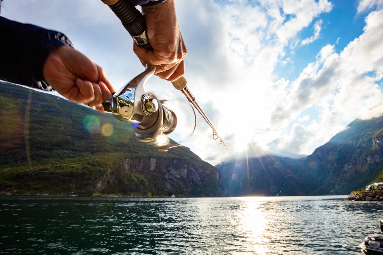 woman-fishing-on-fishing-rod-spinning-in-norway-2021-08-28-02-27-02-utc-1280x853.jpg